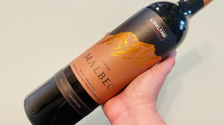 Hand holding bottle of Kirkland Signature Malbec