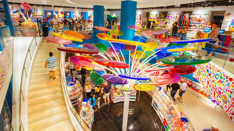 The interior of a Dylan's Candy Bar shop, with a giant lollipop tree in the foreground