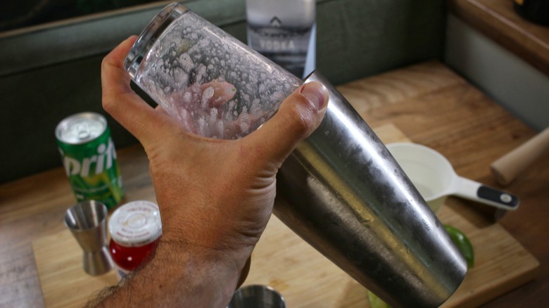 hand shaking cocktail shaker