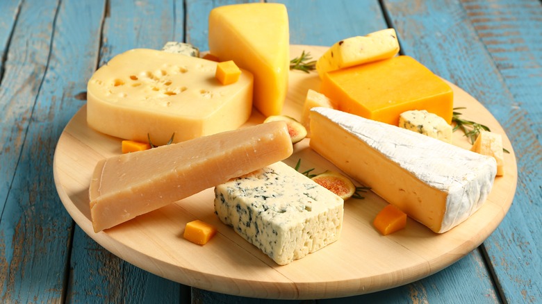 Various cheeses on wooden board