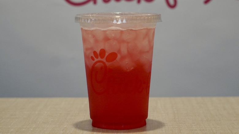 Cherry Berry & Sprite on a tan table in front of a white Chick-fil-A step and repeat