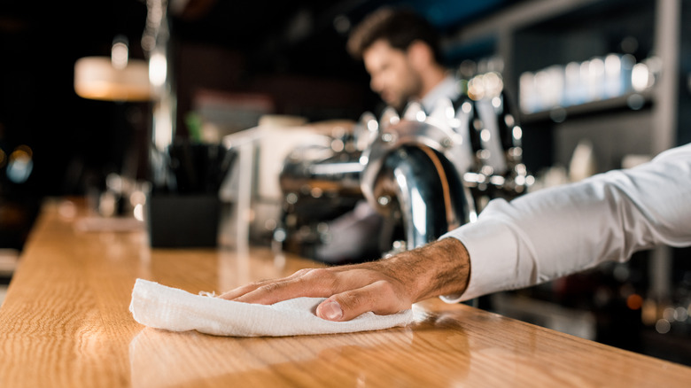 Bartender cleaning counter
