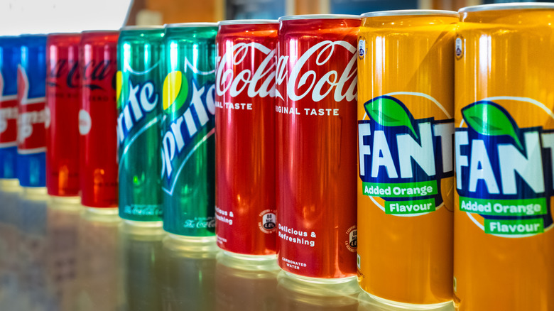 Coca-Cola cans on display on a store shelf