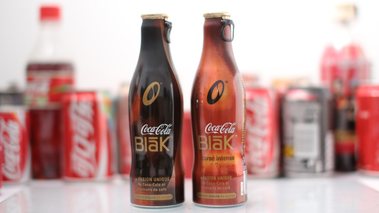 Two bottles of Coca Cola Blāk