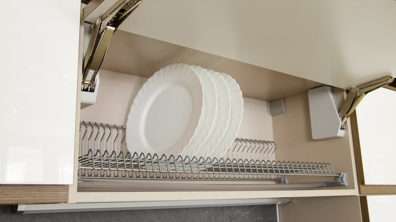 A cabinet converted into a dish drying rack