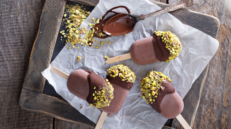 Fudge pops with chocolate drizzle and pistachio topping
