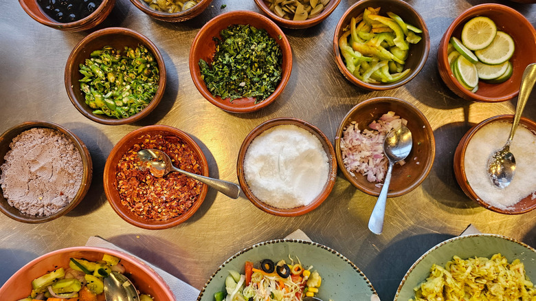 Various vegetables and seasonings in small bowls
