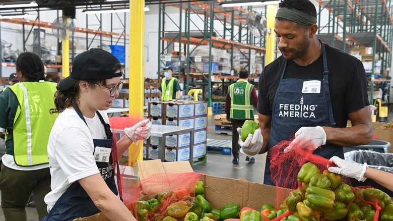 Volunteers help bag peppers at Feeding America L.A. food bank