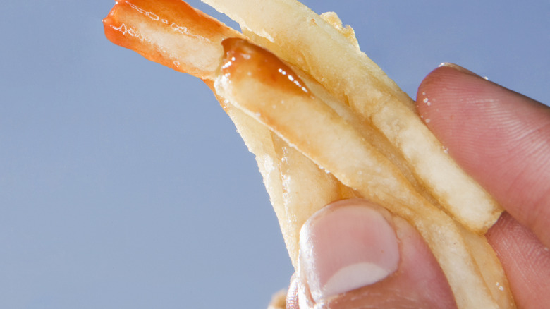 mouth eating fries with ketchup