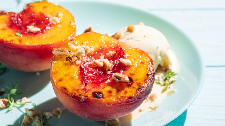 Grilled peaches with vanilla ice cream and nuts