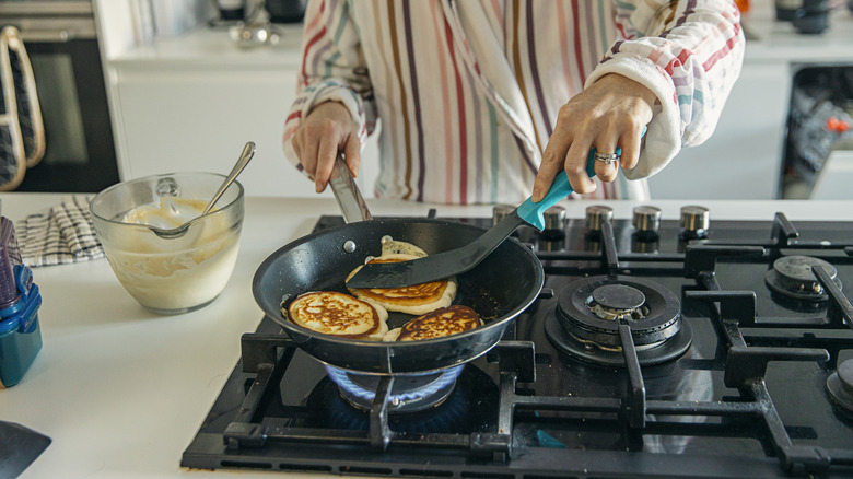 Person cooking pancakes at home