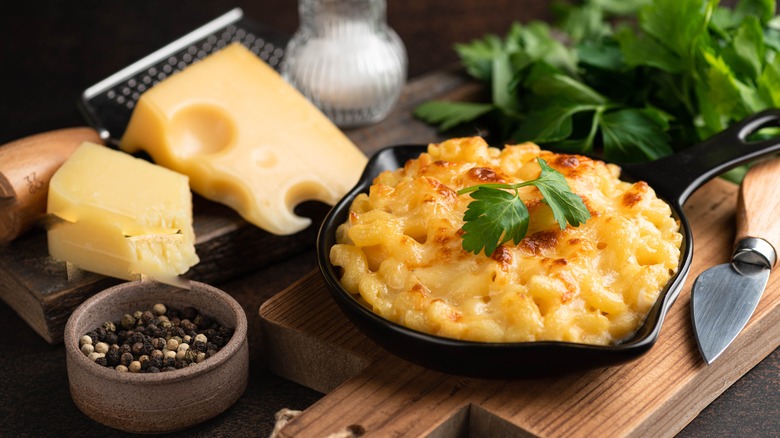 A bowl of baked mac and cheese next to ingredients