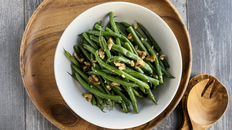 A bowl of green beans and walnuts