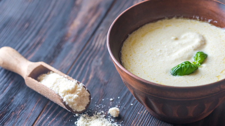 bowl of alfredo sauce and parmesan cheese