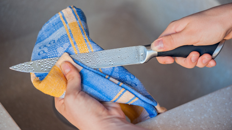 woman drying knife