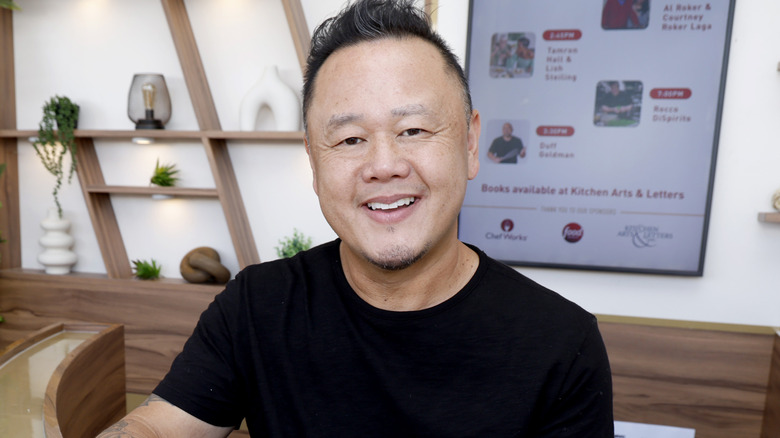 Jet Tila signs a book during the Food Network NYC Wine & Food Festival, 2024