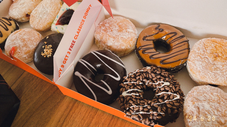 Dunkin' donuts in a boxes on a table.