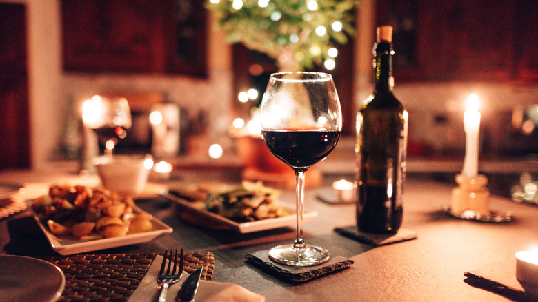 a glass of red wine on a table at home