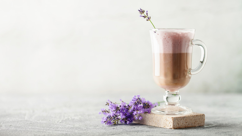Glass cup with coffee and lavender foam