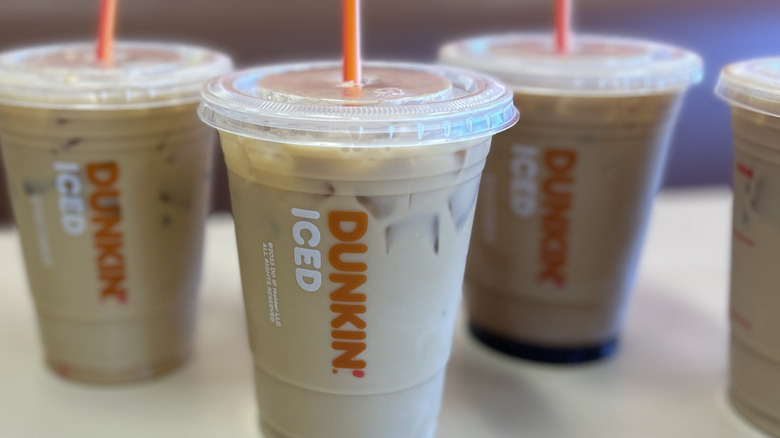 Closeup of three Dunkin iced coffees with the middle coffee in focus