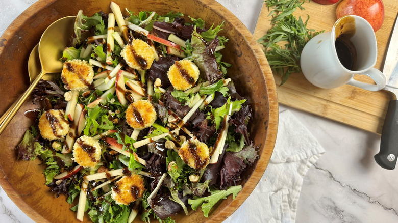 Goat cheese salad in wooden bowl
