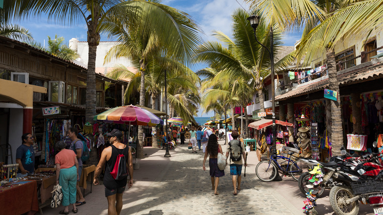 Bustling street in Sayulita, Mexico with various vendors