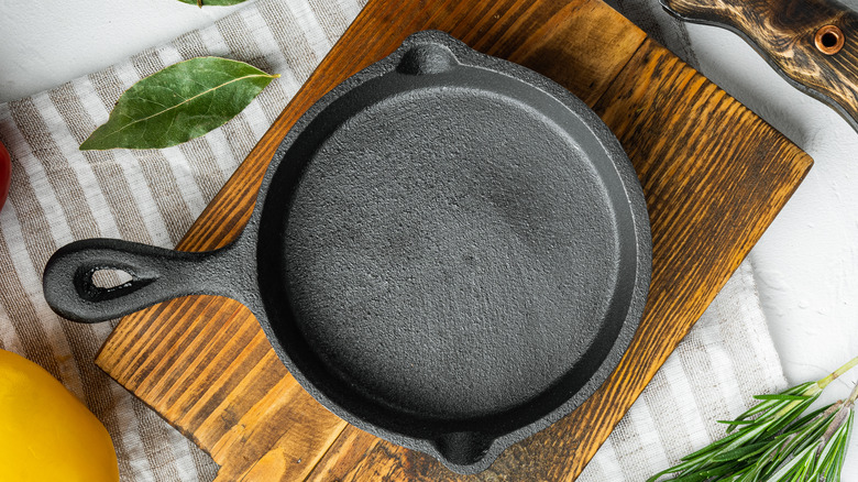 a clean cast iron skillet on a wooden cutting board