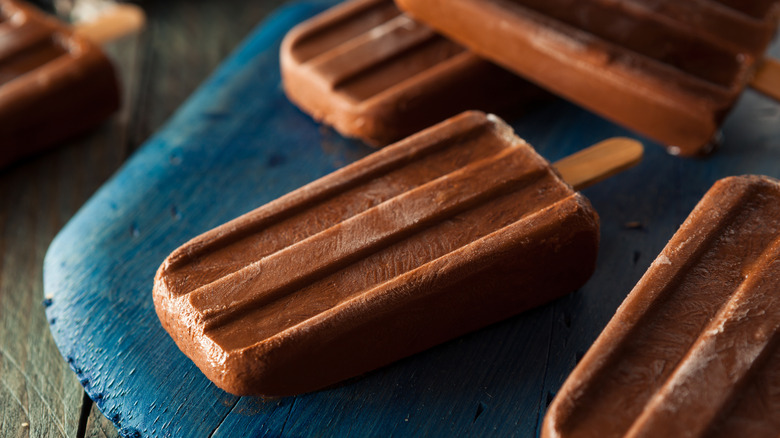 Homemade fudge pops on blue board