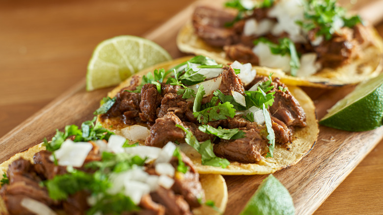 Carne asada tacos with cilantro, onion, and lime.
