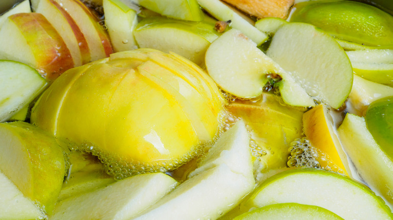Apple slices floating in liquid