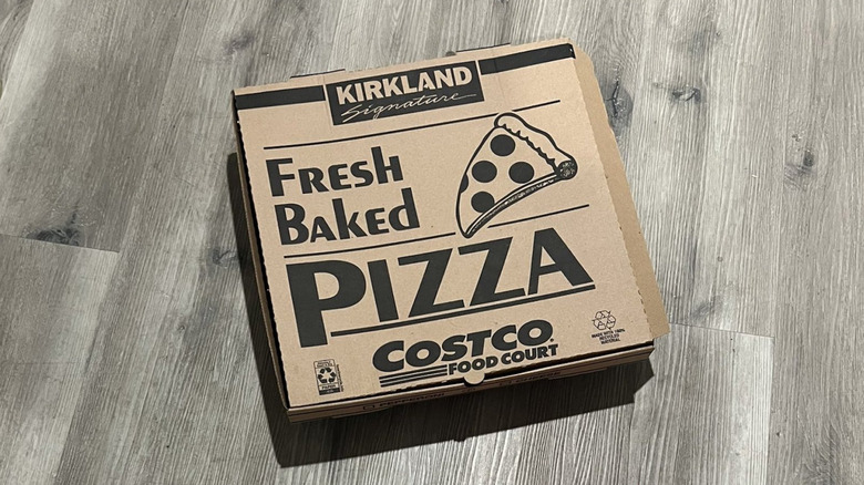 A Kirkland Signature pizza box from Costco rests on a floor