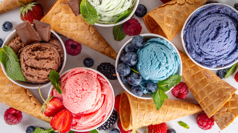 Different flavors of ice creams surrounded by cones