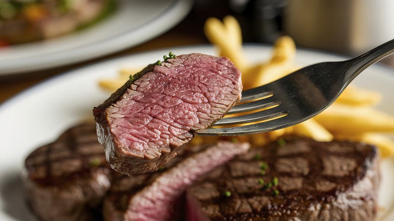 piece of steak at a steakhouse on a fork
