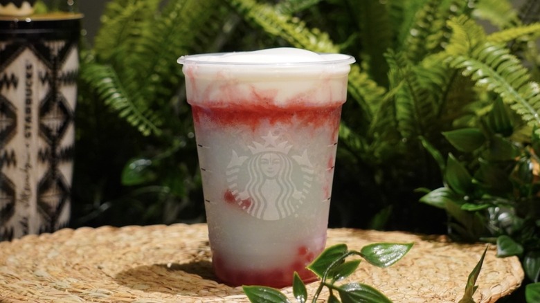Starbucks Firework Frappuccino on a woven placemat in front of greenery