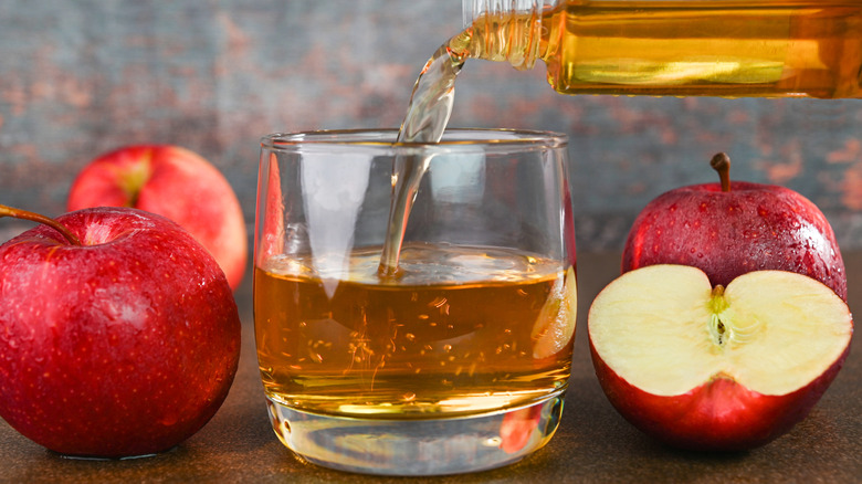 pouring apple juice into a glass