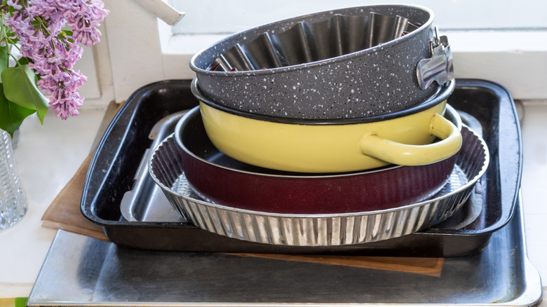 Baking pans and trays stacked in a kitchen