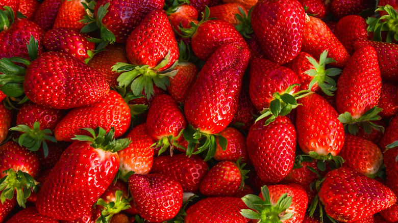 A bunch of strawberries stacked upon each other