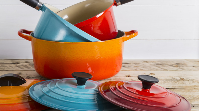 A selection of colorful cookware and lids on a table