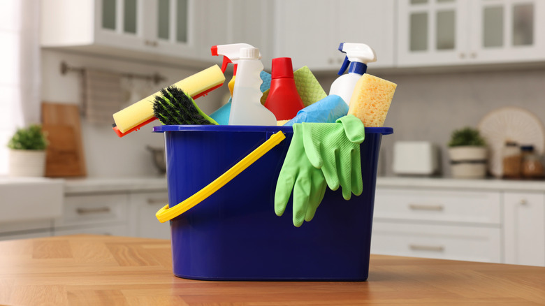 Bucket with cleaning supplies in a kitchen