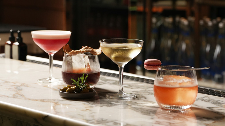 Four different cocktails on a bar