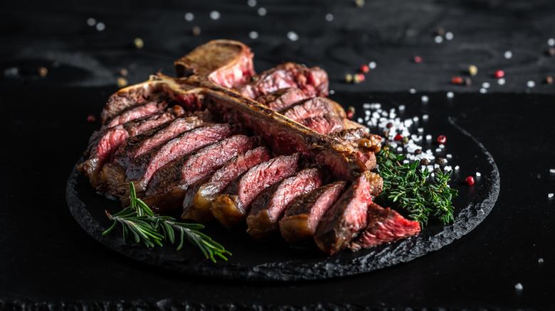 A dry-aged Porterhouse with salt, pepper, and herbs