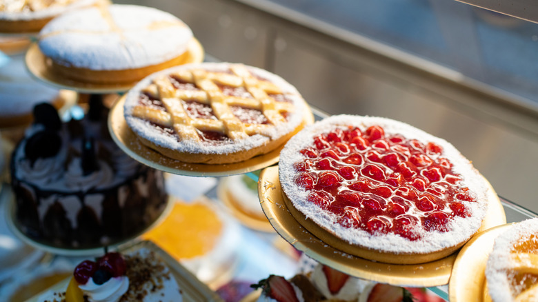 A grocery store display of several types of pies in a display case