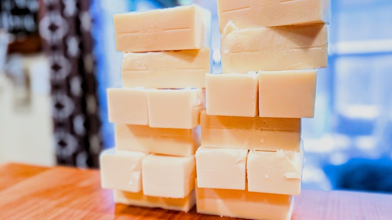 A stack of beef tallow bricks, sliced and sitting on a wooden table