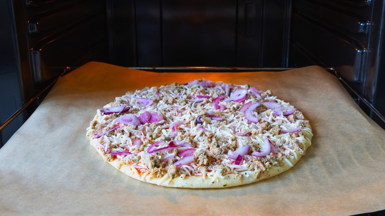 frozen pizza placed into oven