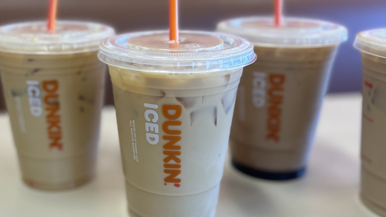 Closeup of three Dunkin iced coffees with the middle coffee in focus
