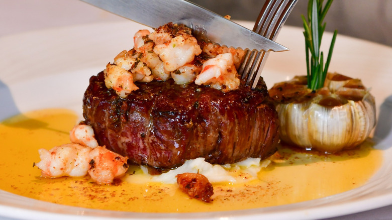 Steak topped with shrimp at The Palm