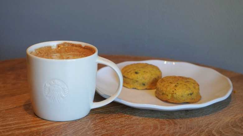 Pecan Oatmilk Cortado and Italian Sausage Egg Bites on a wooden table