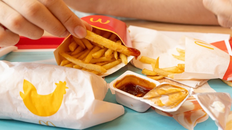 Dipping McDonald's fries into Tangy BBQ Sauce