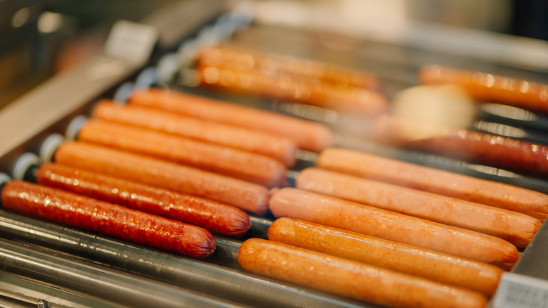 Hot dogs cooking on hot dog roller