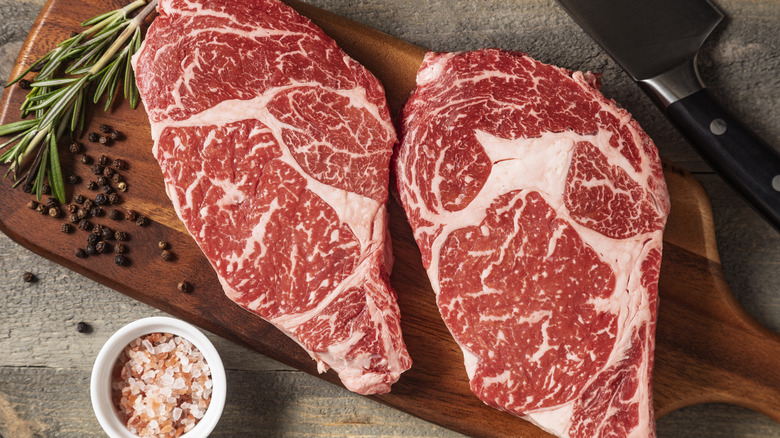 Wagyu beef on a cutting board featuring intense marbling